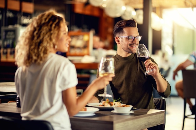 Couple enjoying meal at restaurant with menu on table